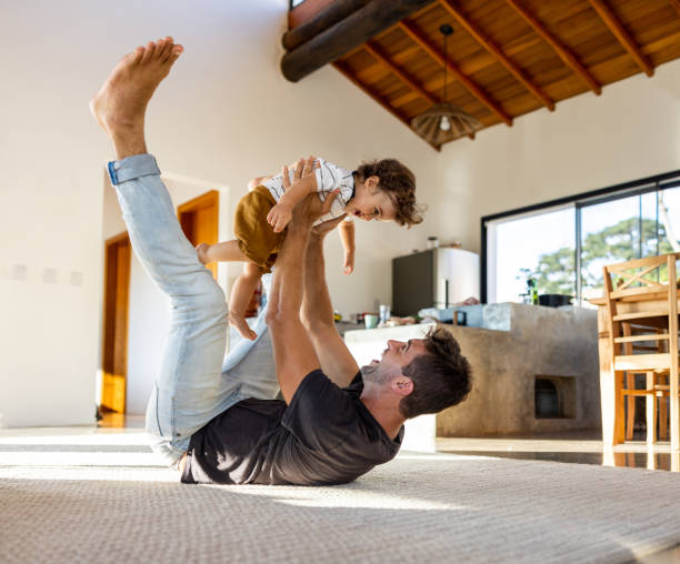istock Happy father looking very excited playing with his son at home 1383518906