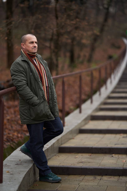 istock Man in winter coat in the park 1383519494