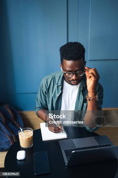 Handsome Male Student Using His Laptop Computer In A Coffee Shop Stock Photo - Download Image Now