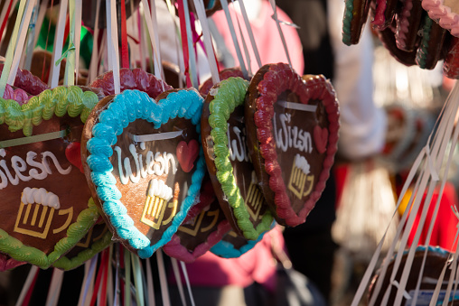 Bonn, Germany - December 5, 2022: Lebkuchen or gingerbread hearts with a variety of sayings and love declarations hanging on display at a candy vendor's stall