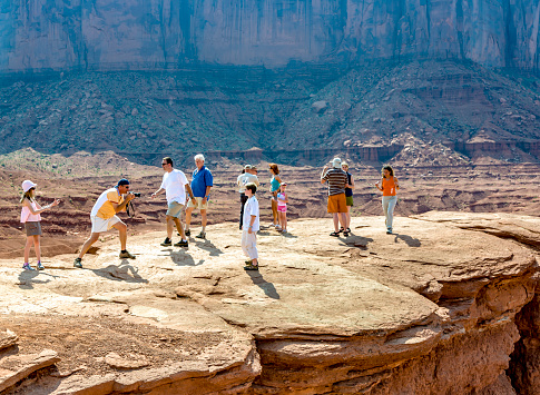 Monument Valley, USA - July 12, 2008: people enjoy the view from John Fords place to the scenic Buttes in Monument Valley, USA.