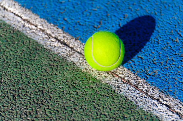 istock Tennis balls on green grass 1383520968