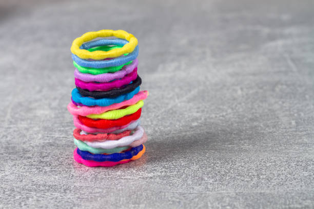 istock a stack of multi-colored hair bands for a girl on a gray background 1383521124