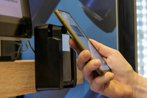 istock Man pays for purchase with smart phone 1383521245