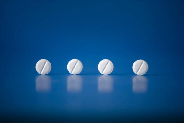 Concept of pills Men Women Kids Health on blue horizontal plane background Hight quality Photo. Fake medicine - placebo is a sham substance or treatment which is designed to have no therapeutic value Medical pills are a medicinal substance in a small round or oval mass meant to be swallowed. A medication is a drug used to diagnose, cure, treat, or prevent disease. statin photos stock pictures, royalty-free photos & images