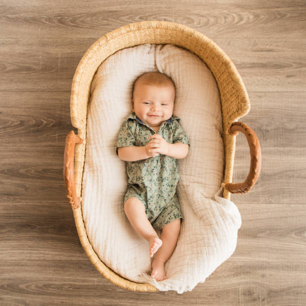 11-Week-Old Baby Boy Wearing a Green Floral Button Down Romper Laying in a Cozy Gauzy Cotton Blanket in a Wicker Moses Basket 11-Week-Old Baby Boy Wearing a Green Floral Button Down Romper Laying in a Cozy Gauzy Cotton Blanket in a Wicker Moses Basket. moses basket stock pictures, royalty-free photos & images