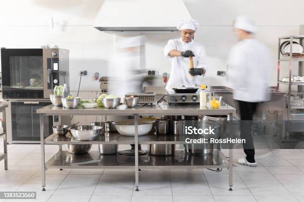 Chef Cooks Working In Professional Kitchen Stock Photo - Download Image Now - Blurred Motion, Chef, Busy
