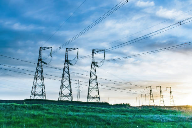 istock Overhead power line transmission tower at sunset. 1383528843