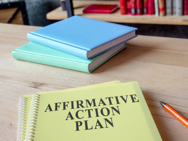 istock Affirmative Action Plan AAP with other papers on the desk. 1383531894
