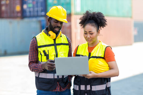 istock Foreman or worker hand holding checklist for writing and checking in goods in container at Container cargo site. 1383532046