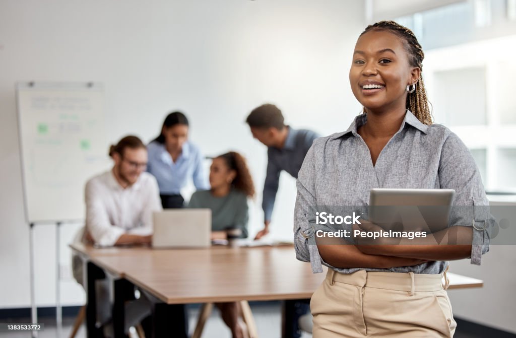 Shot of a businesswoman holding a digital tablet while standing in the boardroom We're the team with all the ideas Manager Stock Photo