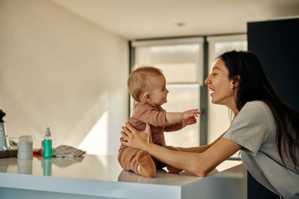 istock Mother playing with her baby 1383535703