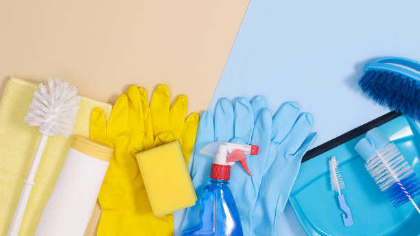 istock Cleaning tools arrangement on pastel blue and beige background. Flat lay house works tools copy space 1383535739