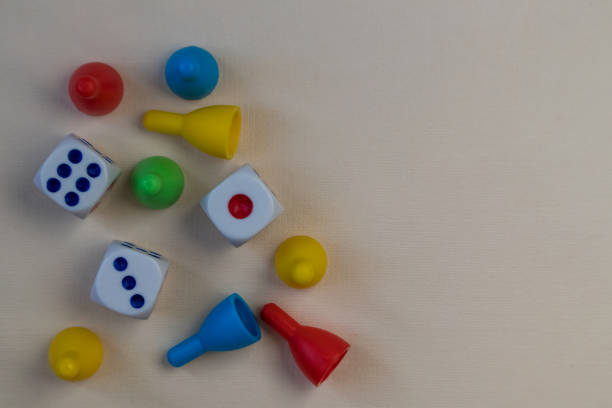 istock A board game of dice and chips on a light background. Time to rest. 1383536837