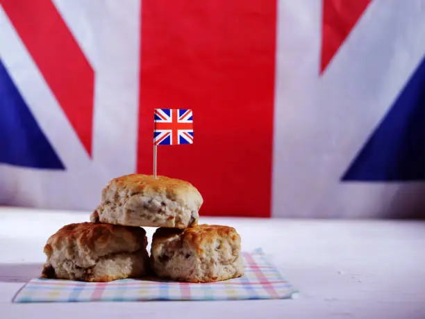 English traditional fresh baked scones on Union Jack background wide shot selective focus