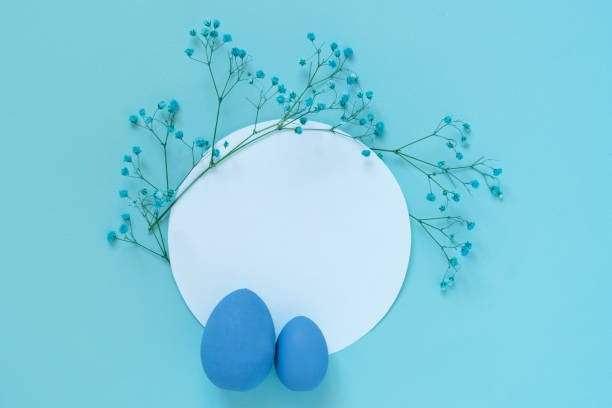istock Easter composition with blue eggs and twigs of blue flowers placed on white circle blank 1383537533