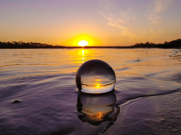 Reflected Evening Sunset reflected in crystal ball at Risby Cove, Strahan, Tasmania fish eye lens photos stock pictures, royalty-free photos & images