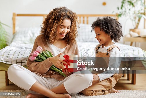 istock Mother and son opening gift box 1383542385