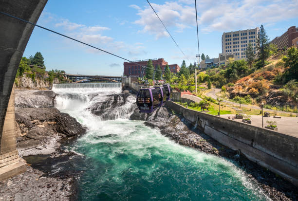 View from a gondola above the Spokane River and Falls of downtown Spokane and Riverfront Park in Spokane, Washington, USA. View from a gondola above the Spokane River and Falls of downtown Spokane and Riverfront Park in Spokane, Washington, USA. spokane river stock pictures, royalty-free photos & images