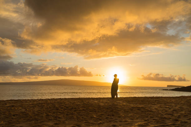 He looks off towards Pacific Ocean in the distance