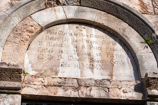Spain, Oviedo - 21 February, 2022: Inscription on the old arched wall of the church San Pedro de los Arcos