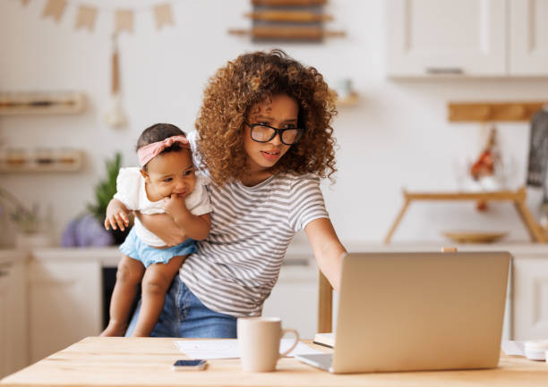 istock Multitasking african american self-employed mother working with baby from home on maternity leave 1383543719