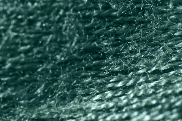 Close up of the fabric of an old yellow mountain raincoat