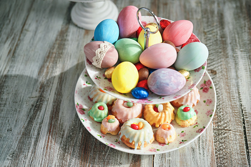 Easter composition with chocolate eggs on blue wooden background