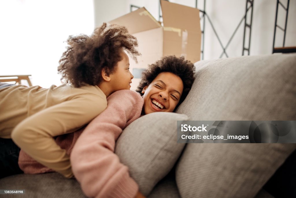 Do they know they'll never love stronger? Two sisters bonding on the couch at home 10-11 Years Stock Photo