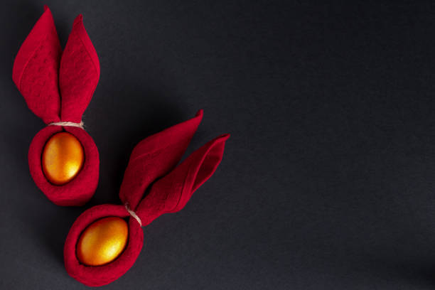 Luxurious golden Easter eggs. Festive decor on black background. Place for text.