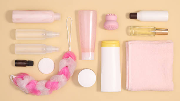 istock Pattern with cosmetics and skin care spa products on pastel beige background. Flat lay 1383550599