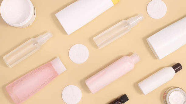 istock Creative pattern with cosmetics and skin care spa products on pastel beige background. Flat lay 1383550813