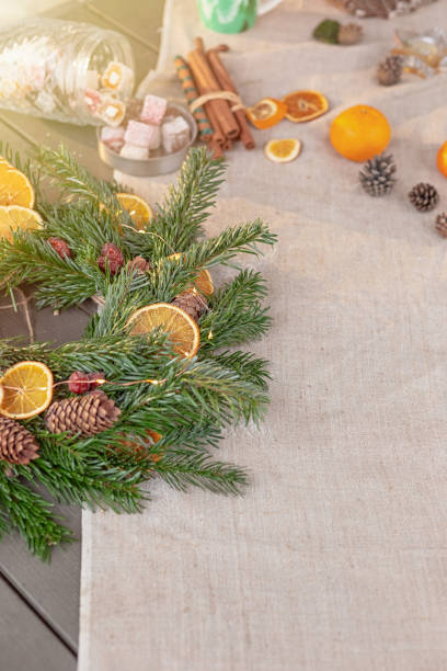 istock Wide banner with natural spruce wreath on a fabric tablecloth 1383553823