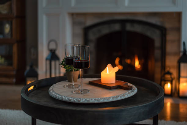 two glasses of red wine at home by candlelight - date night imagens e fotografias de stock