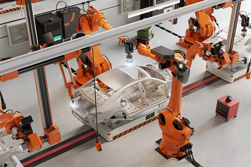 High angle view of car body welding shop with robotic arms welding the car parts. 3d rendering of automatic car manufacturing line in an automobile factory.