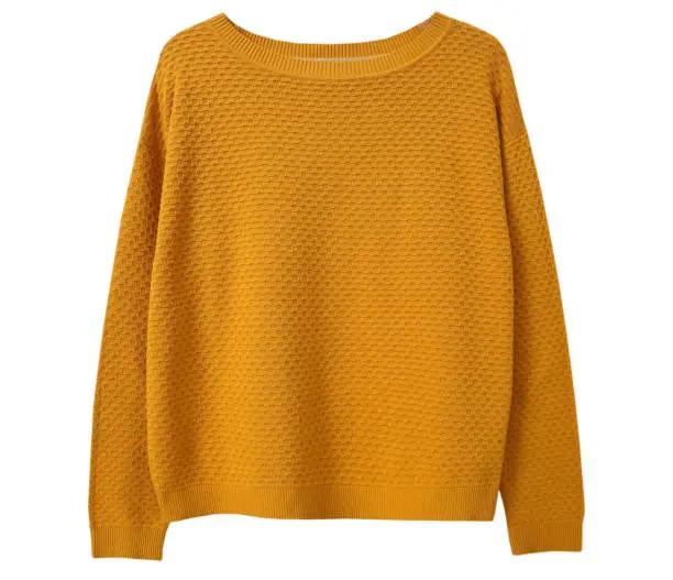 Photo of Yellow sweater isolated on white.Trendy women's clothing..Knitted apparel. Clothes.Jumper.