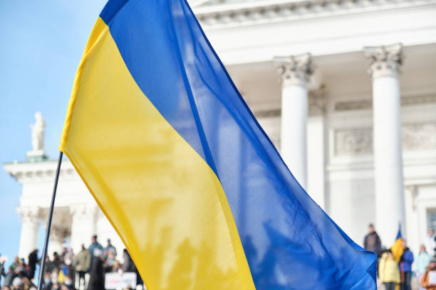 istock Ukrainian flag on the background is the Helsinki Cathedral 1383566689