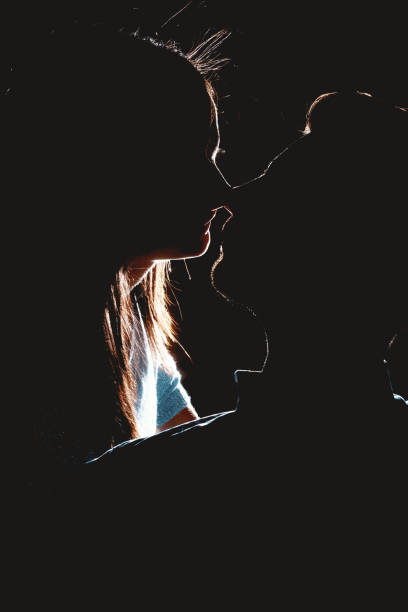 Couple silhouette kissing. stock photo