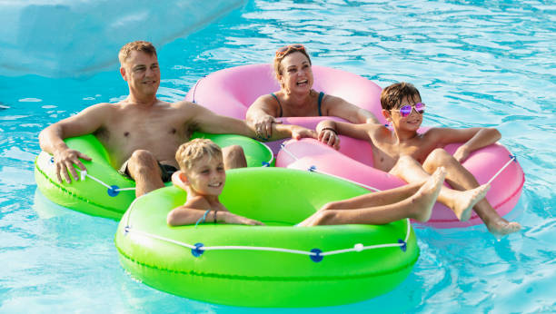 istock Family with two boys float on lazy river at water park 1383589313