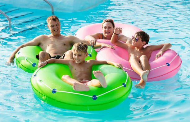 istock Family with two boys float on lazy river at water park 1383589321