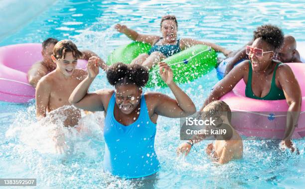 Multiracial Friends And Family Splashing On Lazy River Stock Photo - Download Image Now