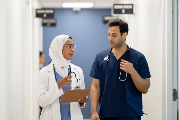 istock Medical Staff Walking the Hallway Together 1383615340