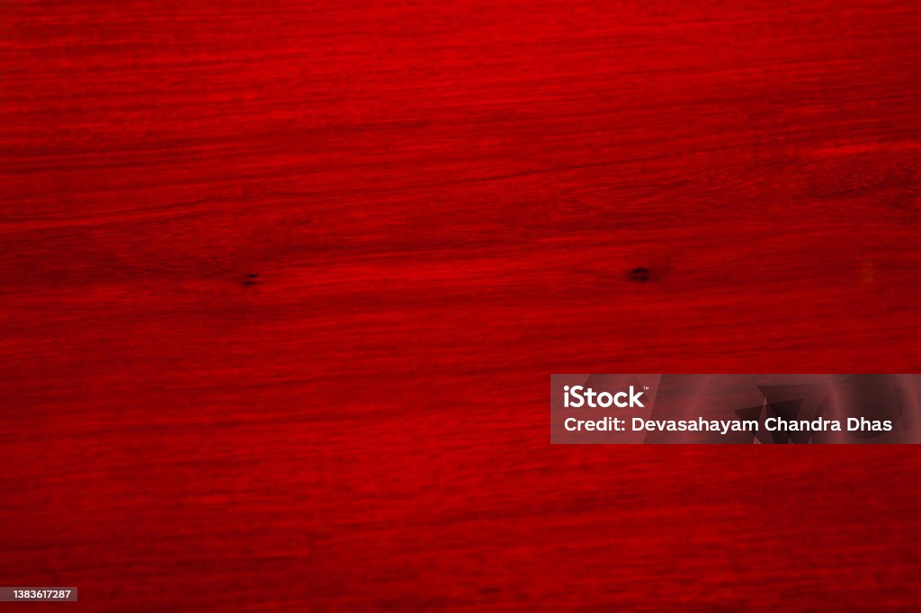 RIch Red Chinese Rosewood Background Fills The Frame Bogotá, Colombia - A highly polished Chinese Rosewood table with attractive grain and a couple of knots fille the frame. The wood grain has been placed horoizontally. Abstract Stock Photo