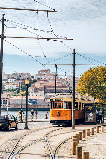 Historical retro yellow tram in Porto city centre during autumn.
