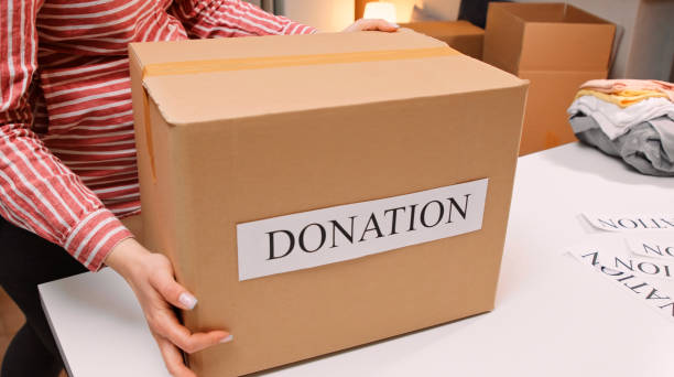 istock Pregnant woman preparing donation boxes. Charity. 1383622049