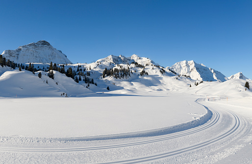 Winter landscape with cross-country ski trail in the mountains. Hochtannberg, Vorarlberg