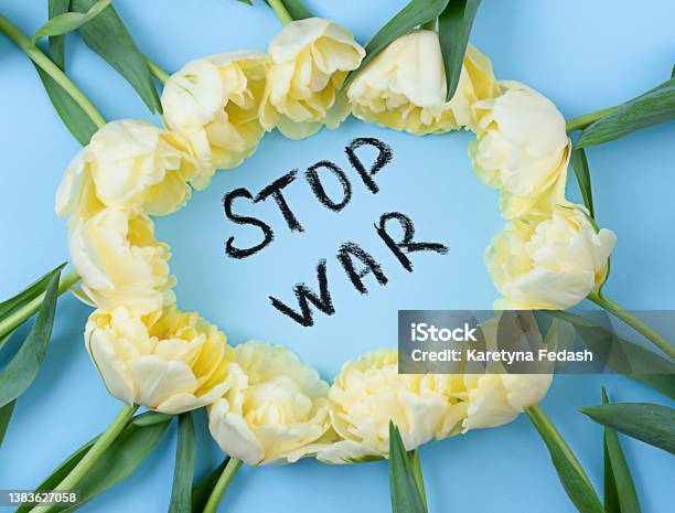 Yellow Tulips On A Blue Background With A Black Inscription Stop War The Concept Of The War Between Russia And Ukraine Stock Photo - Download Image Now