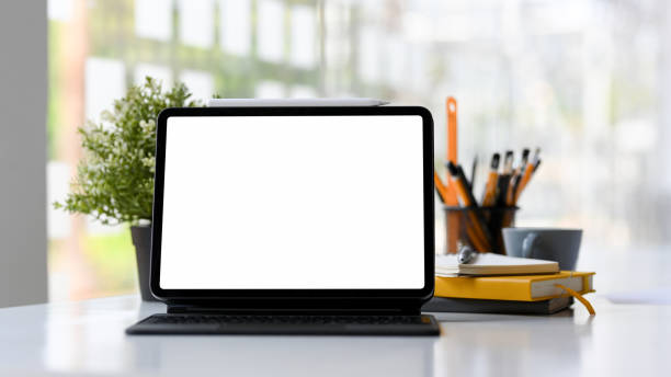 istock Digital tablet touchpad mockup with wireless keyboard on office desk. 1383691440