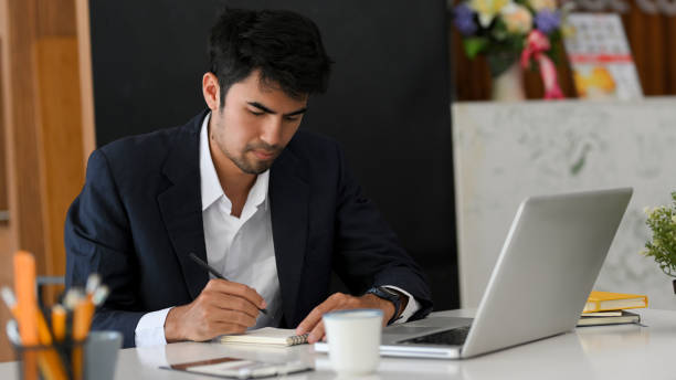 istock Businessman in formal suit focused on his work project 1383691494