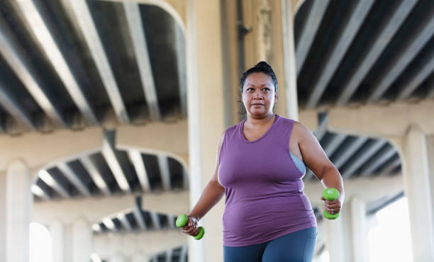istock Pacific Islander woman exercising with dumbbells 1383691956